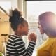 Black woman and little daughter smiling